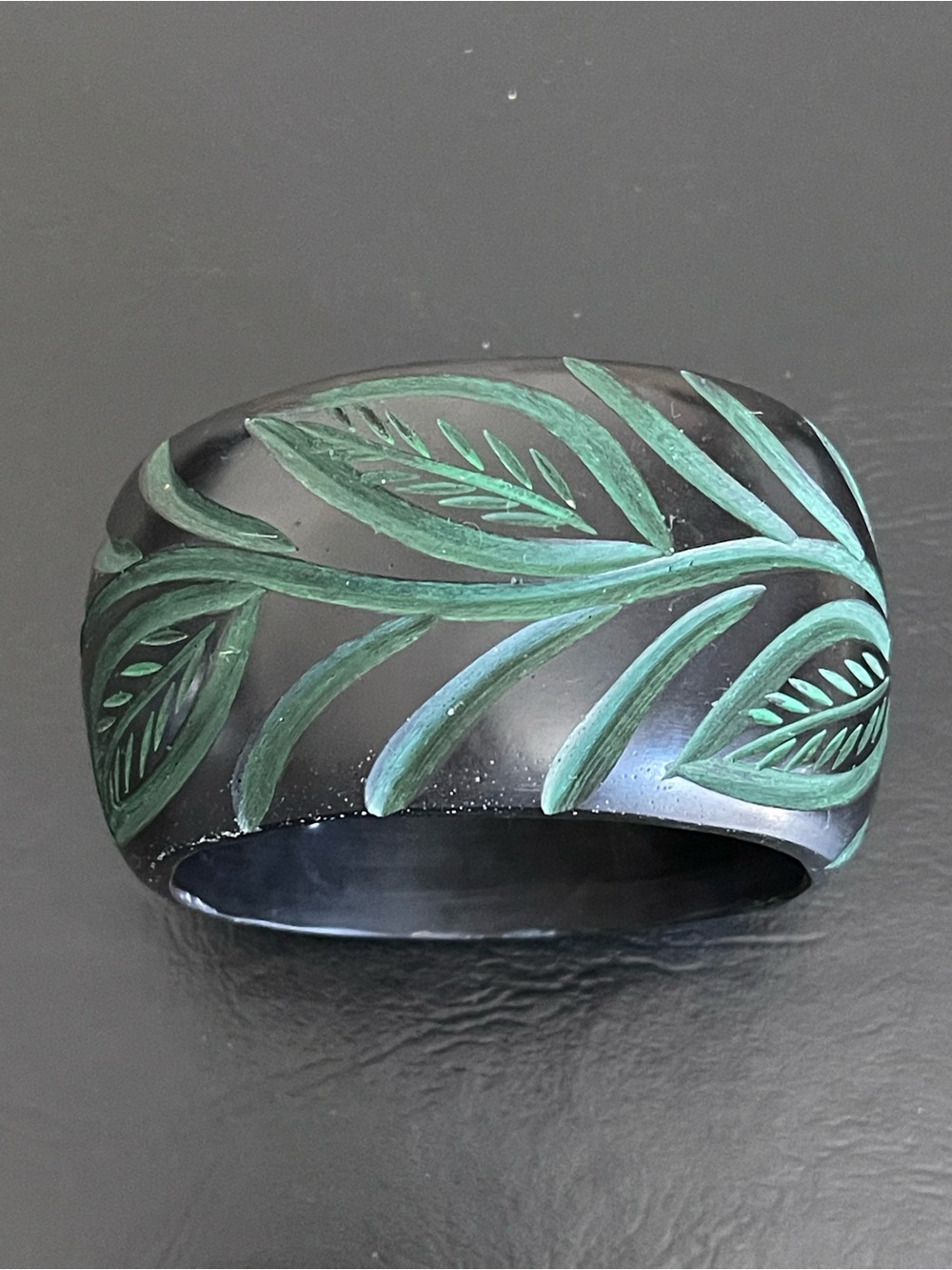 Vintage Hand-Carved Black Resin Bangle with Green Leaf Motif .